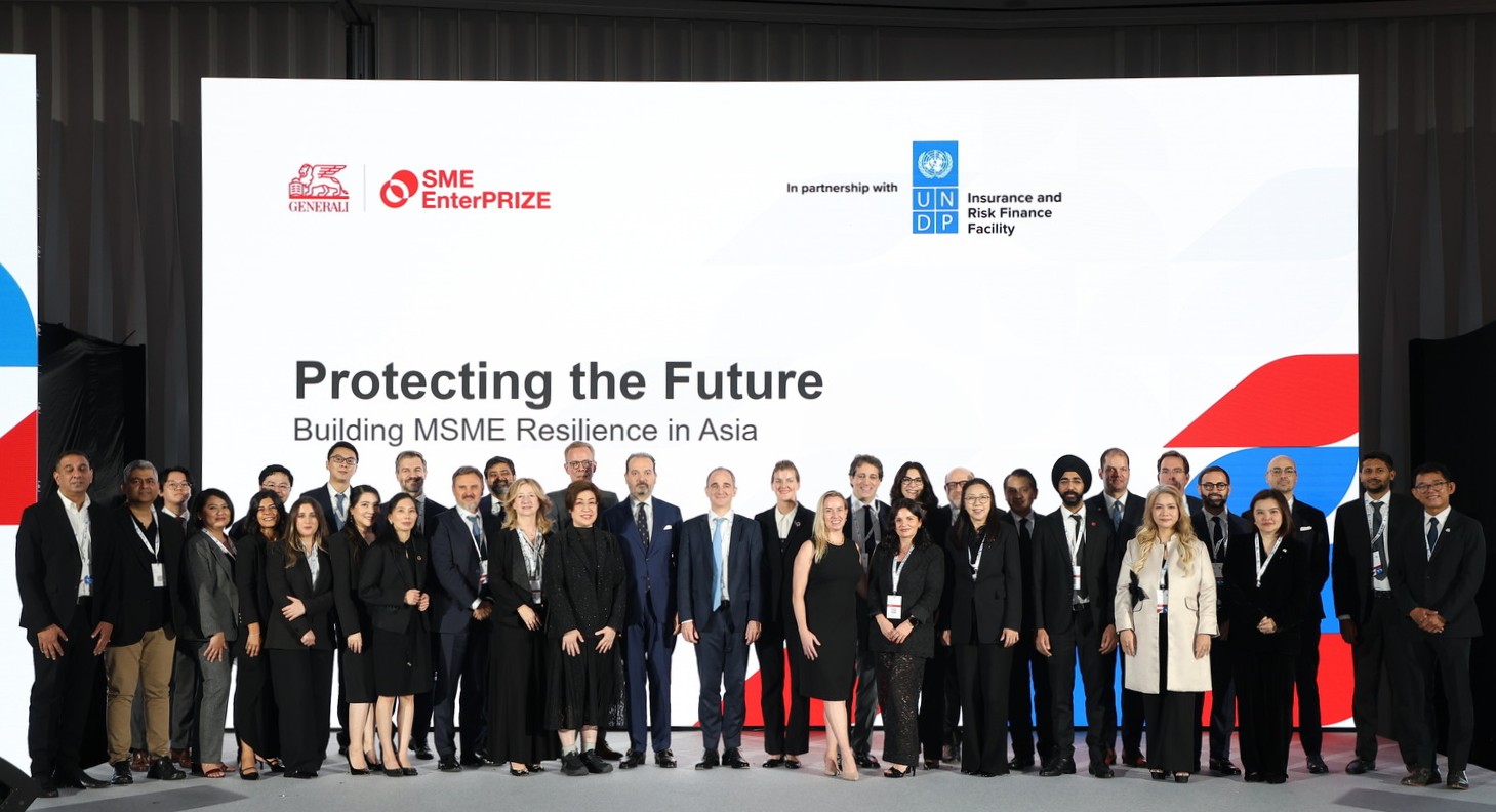 Participants pose on stage at Protecting the Future: Building MSME Resilience in Asia, with Generali and UNDP branding behind them.